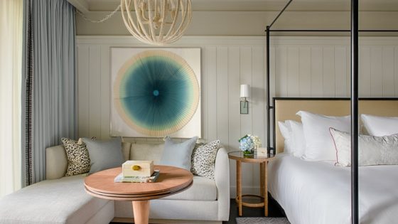 Soft white interiors compliment accents of ocean blue art