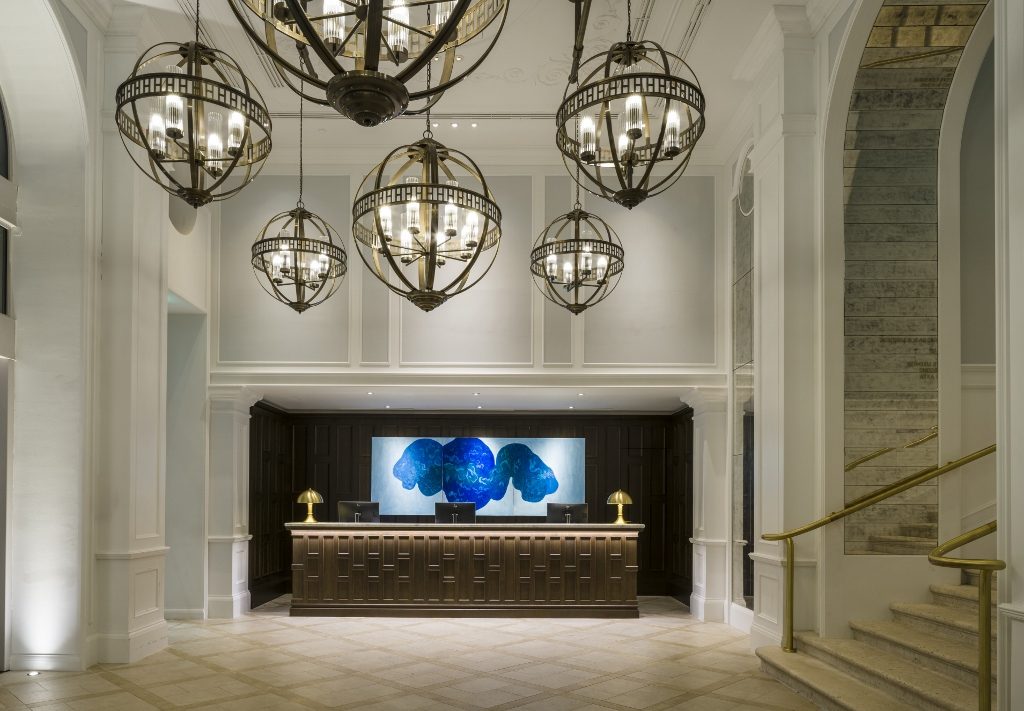 Reception desk with bespoke marble-topped and timber-panelled desk with rear artwork triptych by Croatian artist Antonia Čačić