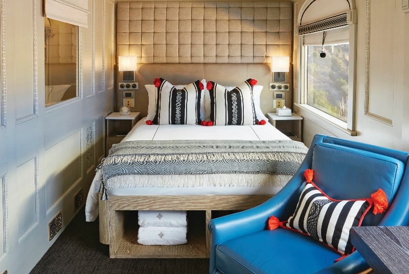 Luxury room in train. Wooden bed frame and luxury blue seating