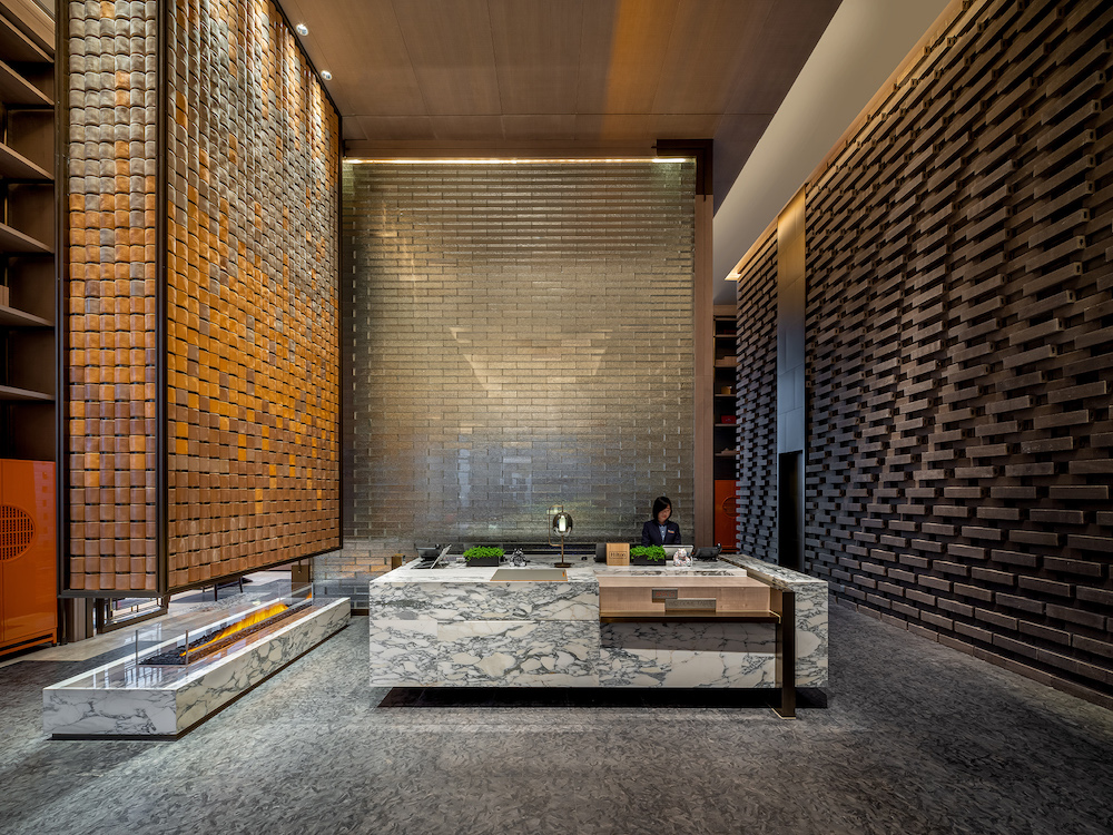 Large, open and very minimalist lobby with brings as wallcoverings.