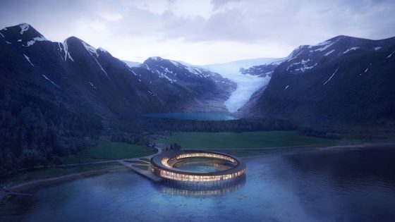render of hotel in the middle of water next to snow-capped mountains
