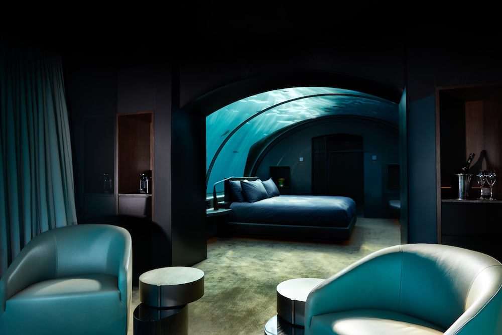 Underwater suite featuring luxury bed and furniture