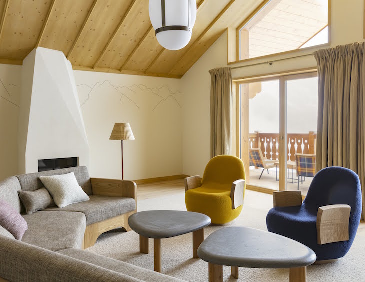 Yello and blue contemporary arm chairs in light chalet-style room