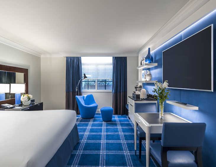 Sofitel London St James luxury room with blue tartan carpets and blue modern furniture