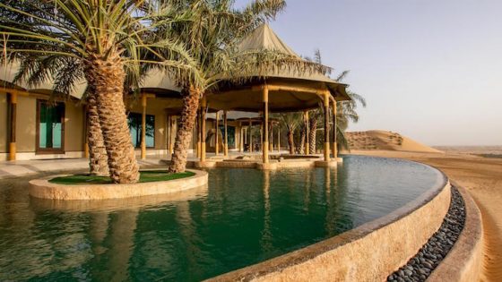 A luxury pool and tented accommodation in the middle of the desert
