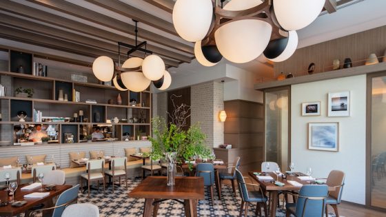 A contemporary dining area in a hotel with bold orb lighting