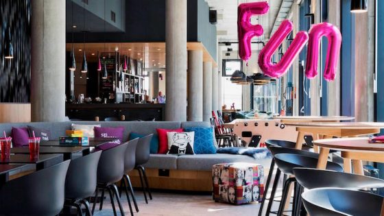A fun living area inside Moxy Hotels with industrial design