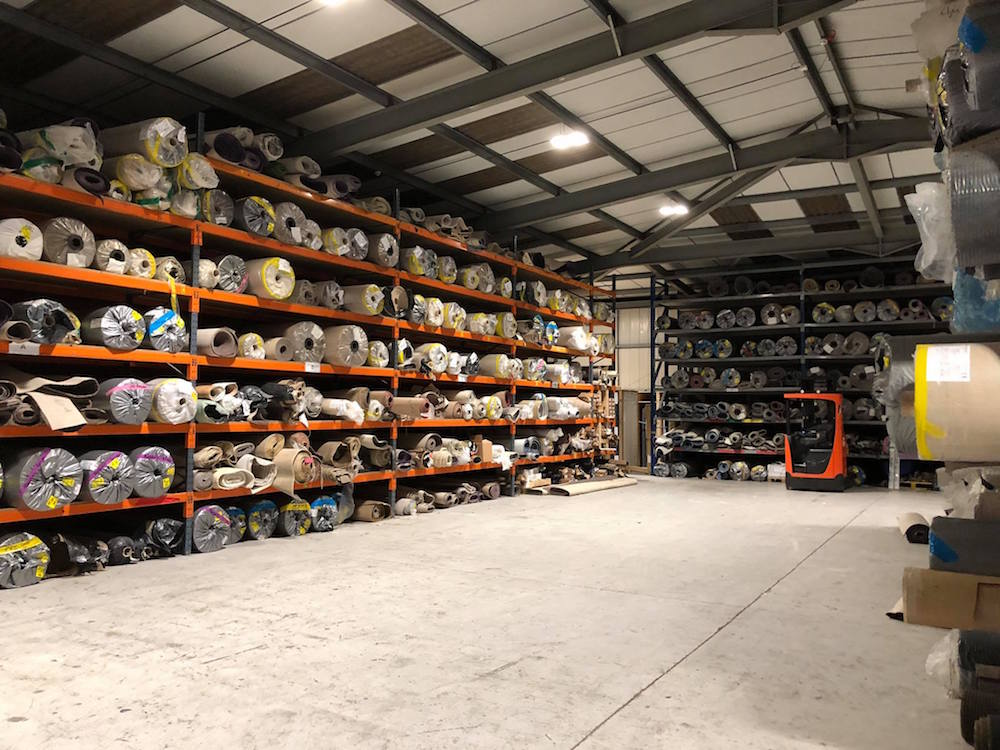 Image of rolled carpet in a warehouse