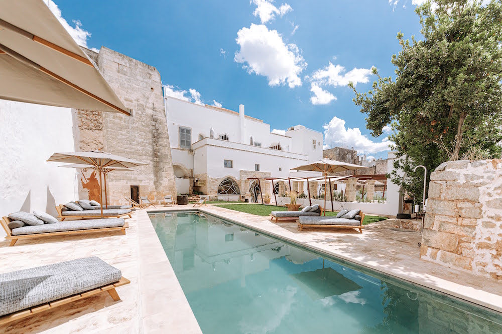 A luxury pool with white washed buildings