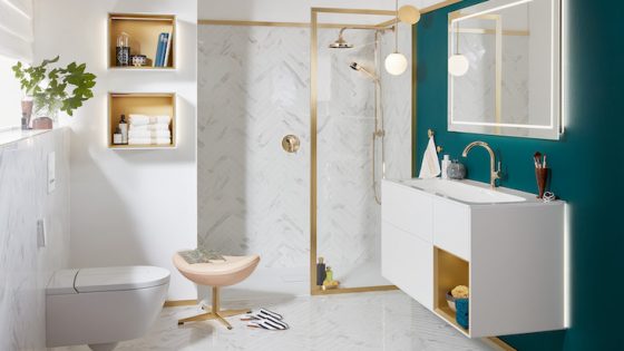 A modern bathroom with gold fittings and white and blue interior design scheme