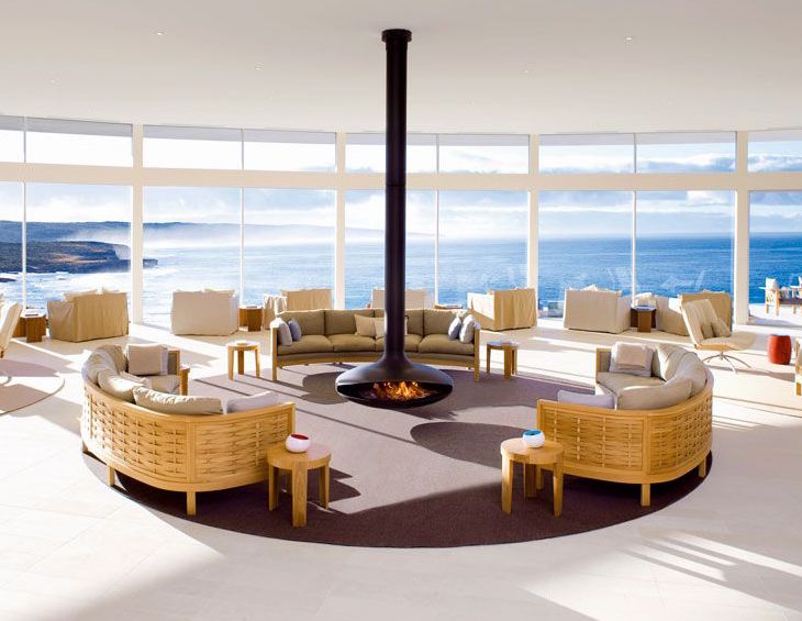 Image of luxury public area with fire in the middle of room over looking an incredible sea view