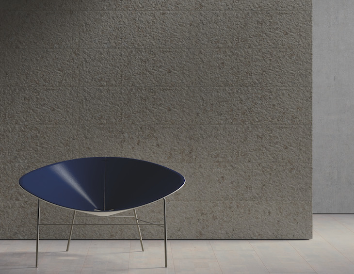 Image of blue modern chair next to cork wallpaper