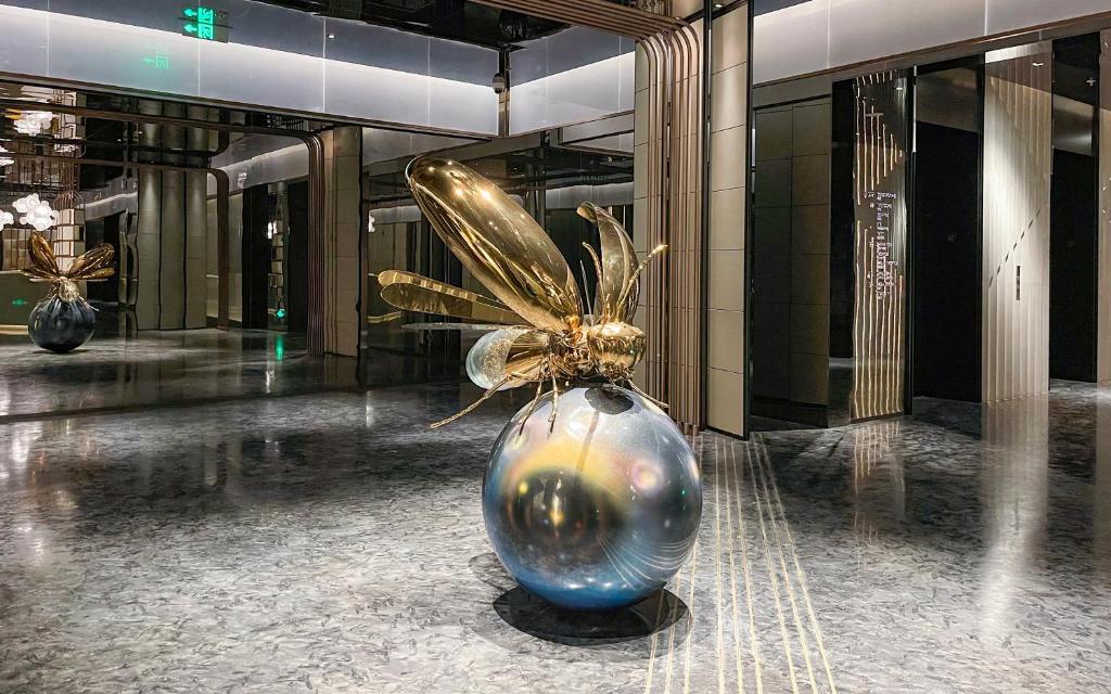 A sculpture of a bee on a globe