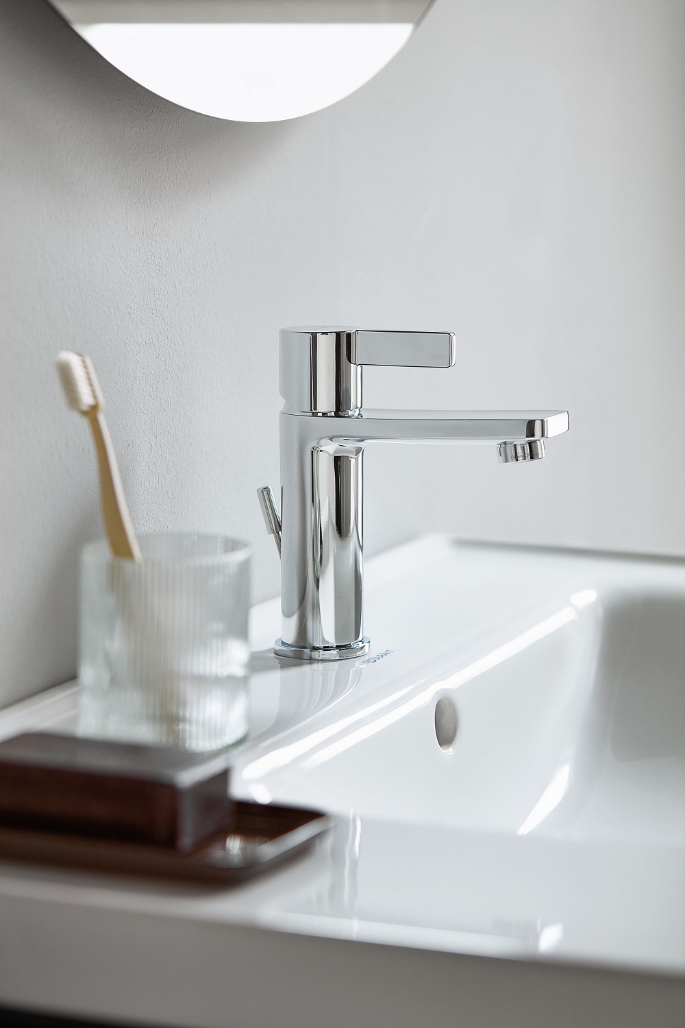 Close-up of white basin and chrome tap