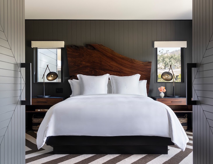 Hotel design | Four Seasons Napa Valley bedroom with wooden headboard, white sheets and black and white striped carpets