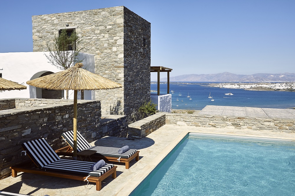 the white and stone walls of villas at Acron Villas-Cycladic Architecture