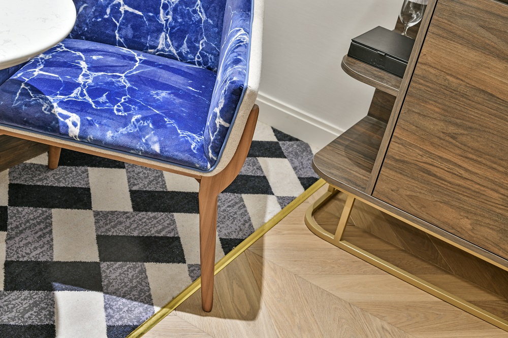blue cream and wood interior scheme with blue chair and carpet