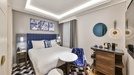 blue and white bedroom with wooded surfaces at lost property hotel in london