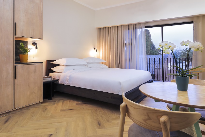 contemporary hotel bedroom design with natural wood surfaces at Hyatt House Johannesburg