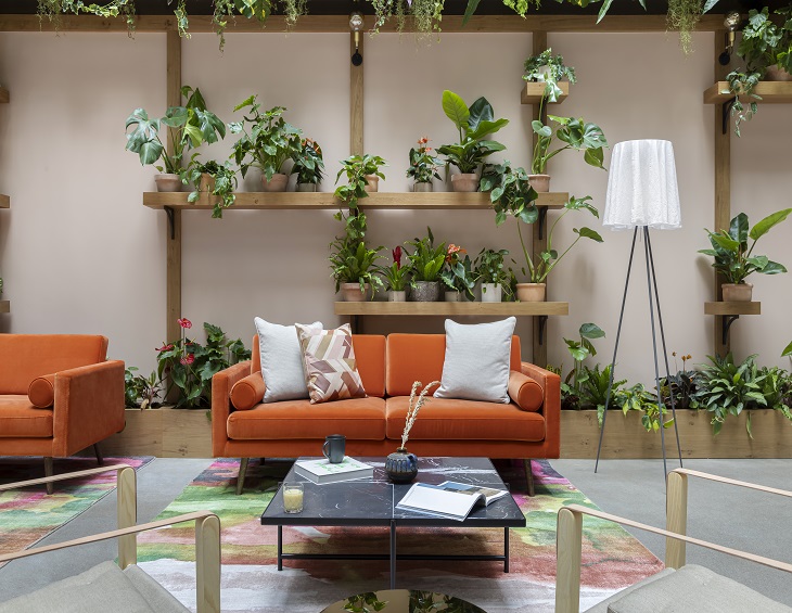 Orange couch and indoor plants at Beckett Locke hotel