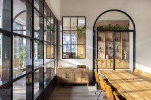 glass walls and wooden table provide contrasting surfaces at Beckette locke hotel
