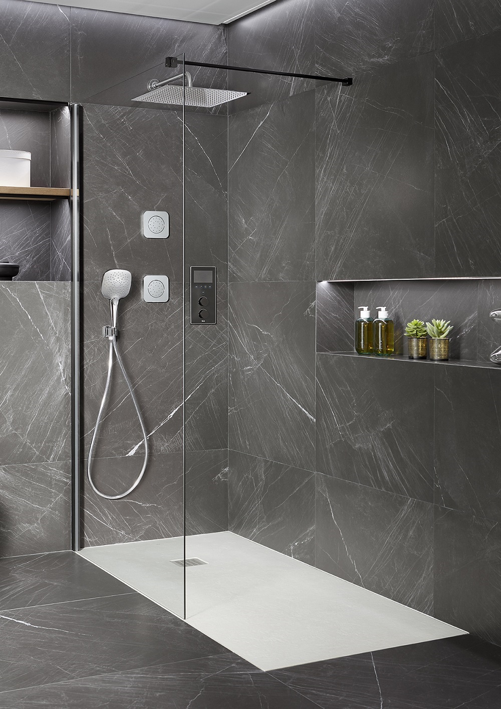 E-shower by roca with clear glass screen and marble surfaces
