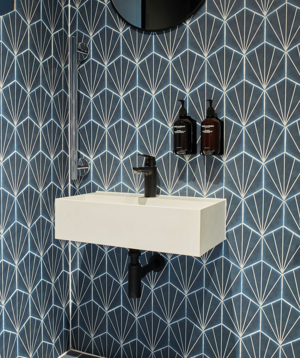 Close-up of bathroom with geometric wall and floor tiles