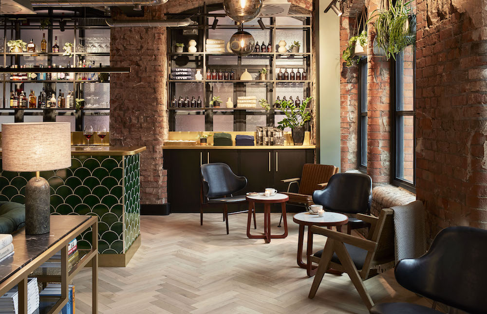 Cosy lobby inside LEVEN Manchester with red exposed brick