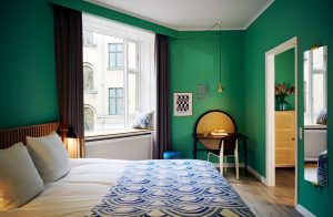 bright green walls in guestroom at Coco Hotel