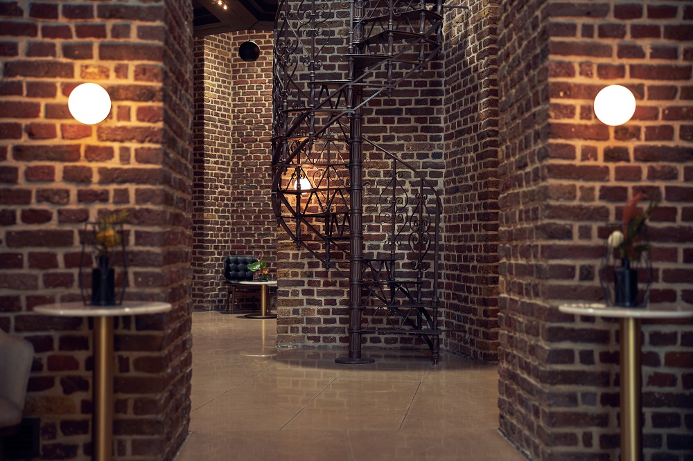 spiral staircase and intricate brickwork feature in the design of hilton curio collection wasserturm hotel