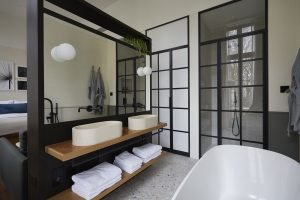open plan design with bath and shower at inhabit queens park london