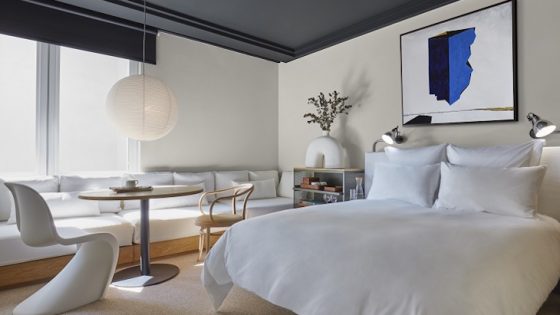 guestroom in white and grey with contemprary art and blue accents at 100 shoreditch