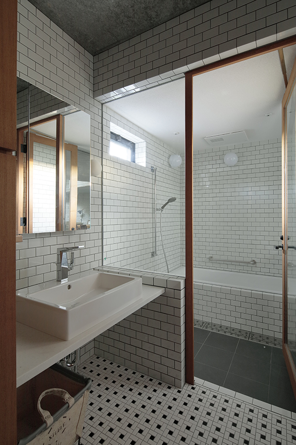 A tiled bathroom inside PHASE DANCE architectural structure in Japan