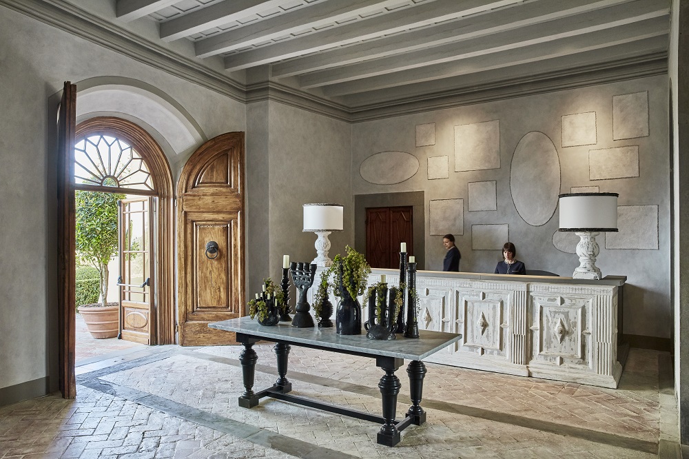 reception area at Castello Del Nero in shades of gray designed by Paola Navone