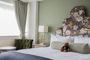 hypnos bed with floral headboard in guestroom at Billesley Manor