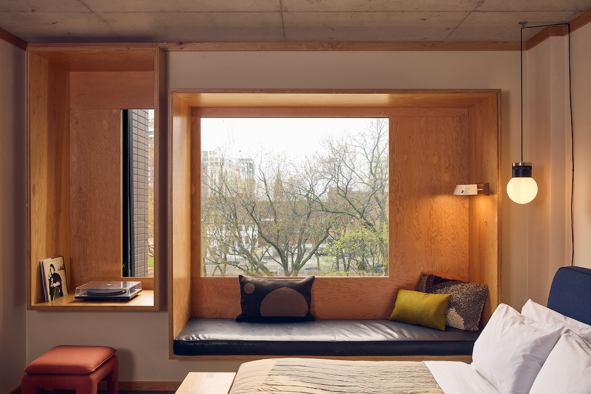 Guestroom inside Ace Hotel Toronto with wooden interiors and modern design scheme