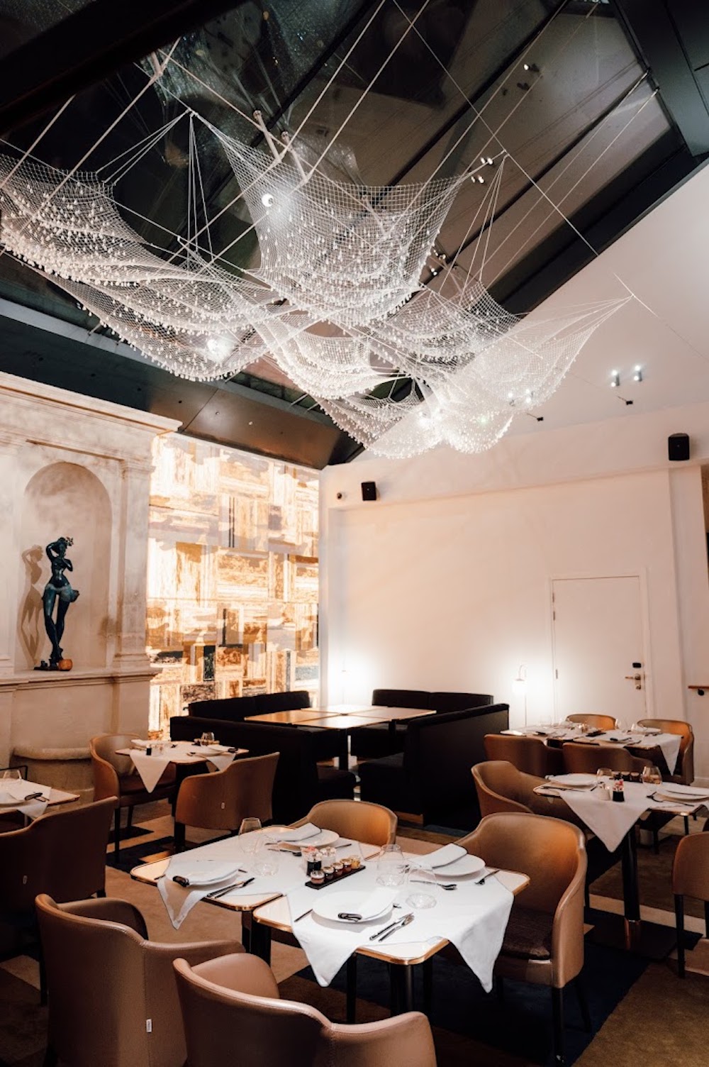 A striking wire-net chandelier inside restaurant at Fauchon L'Hotel