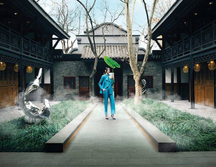 Woman standing in courtyard at The Temple House Hotel Designs