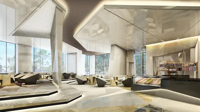 A render of the large luxury lobby, with accents of muted gold, inside Hilton Bahrain