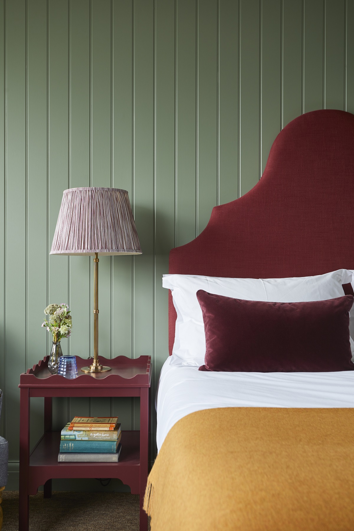 raspberry red headboard and green walls in guestroom at the retreat elcot park