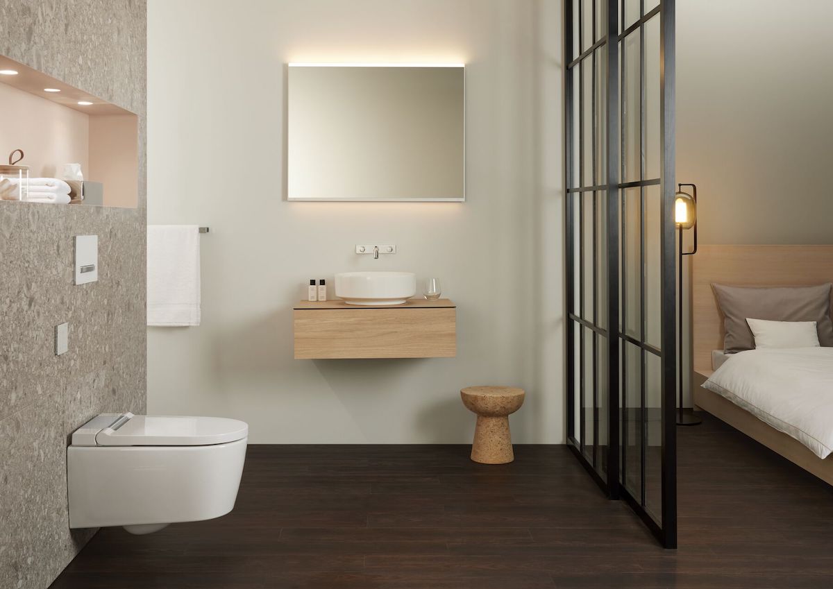 Soft tones in modern bathroom that has a sliding door into the bedroom