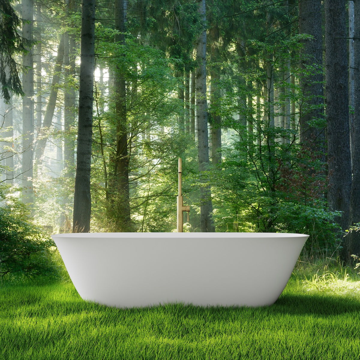 A freestanding white bath in the middle of a forest
