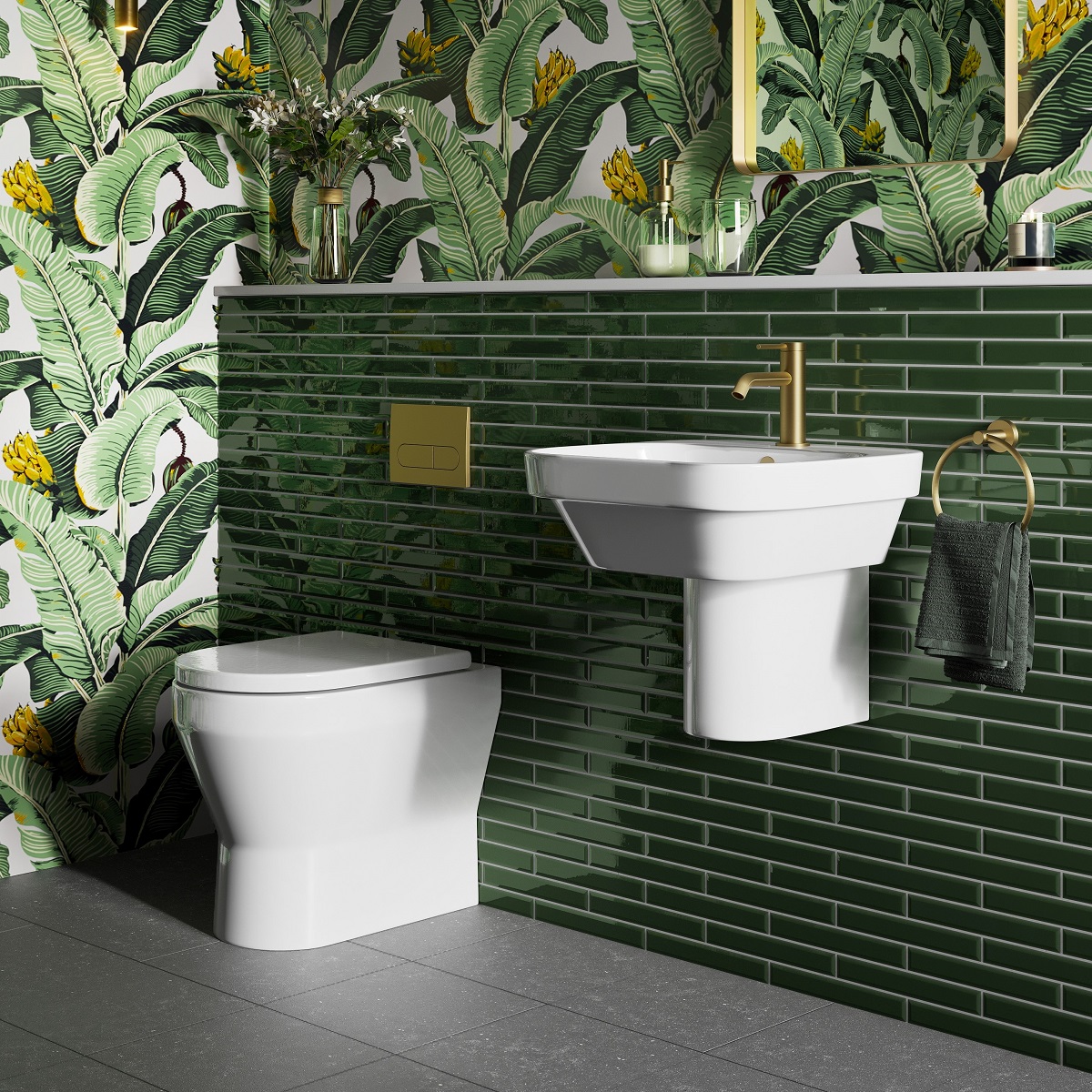 dark green tiles and tropical print wallpaper in bathroom by Britton