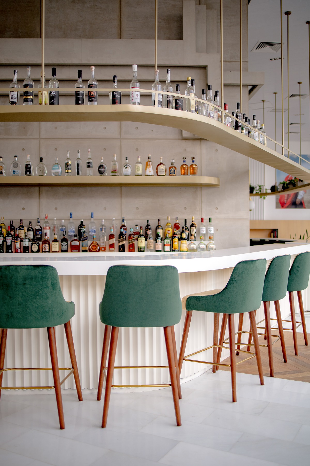 Curved bar design with green chairs in MET Hotel