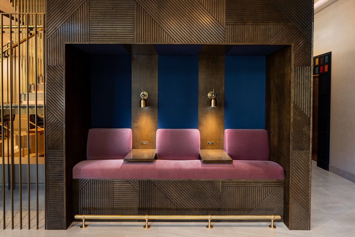 blue, wood and gold accents in seating corner of the hotel lobby