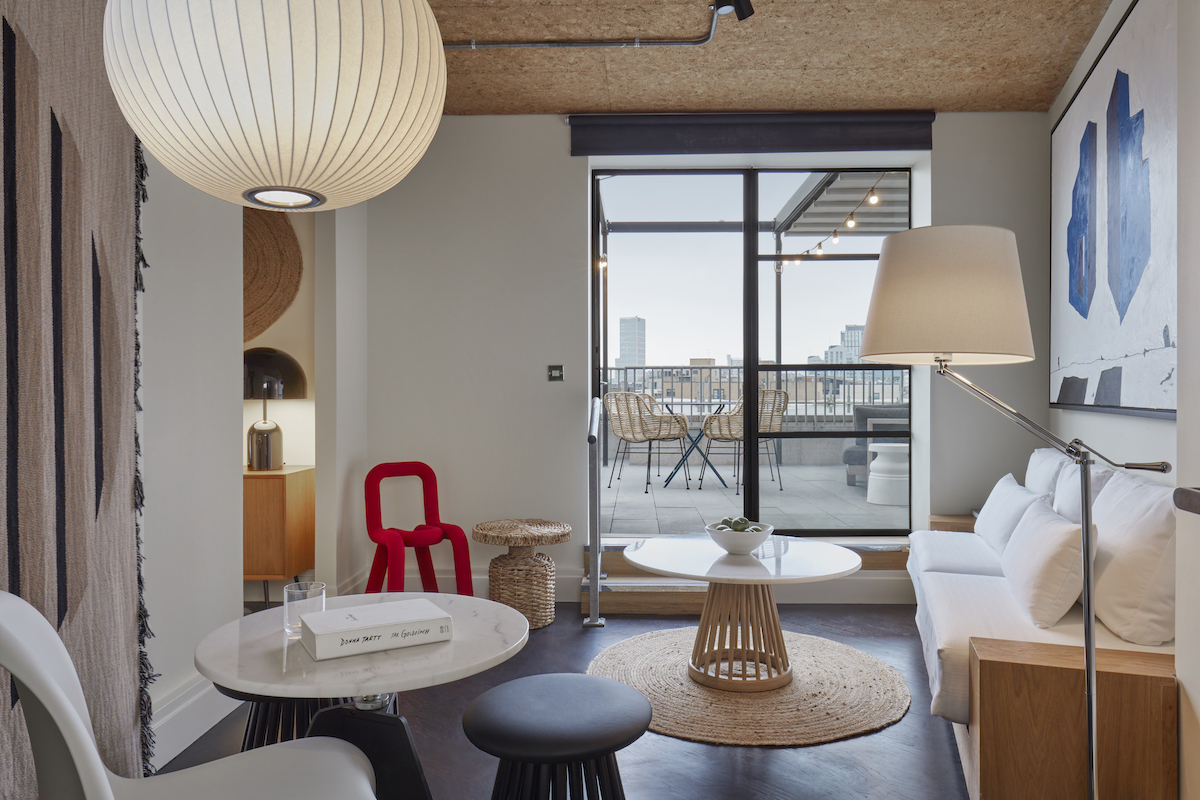 One Hundred Shoreditch suite, with red chair and calming interior design