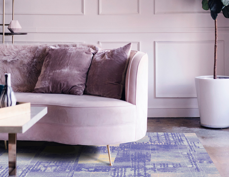 A lilac sofa and purple, textured run in living room