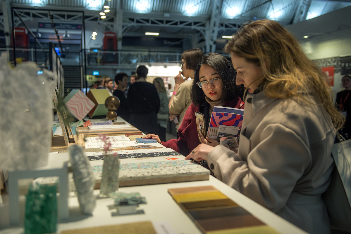 Two women looking at surfaces and materials