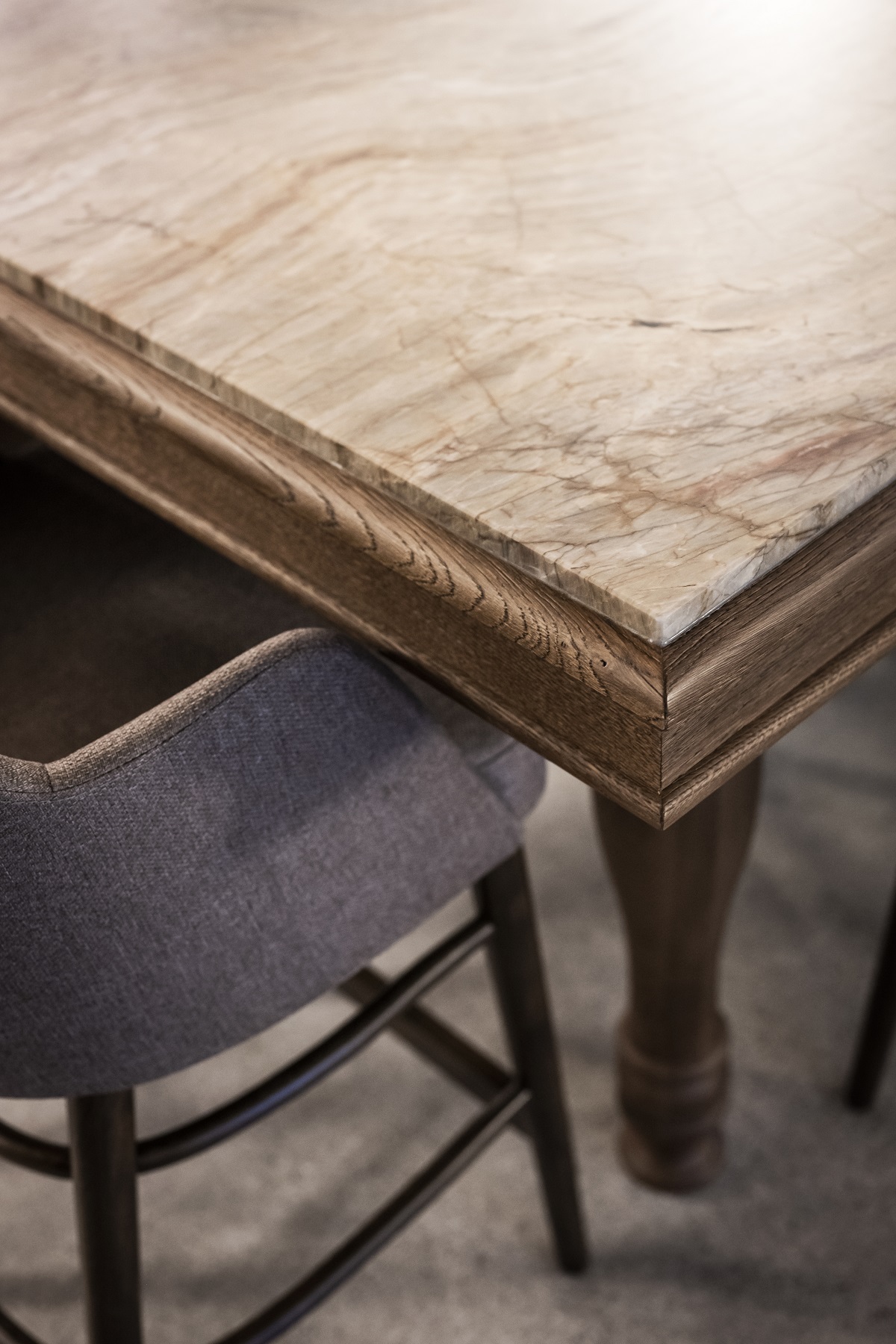 detail of wooden table with marble surface at Bogen by noa