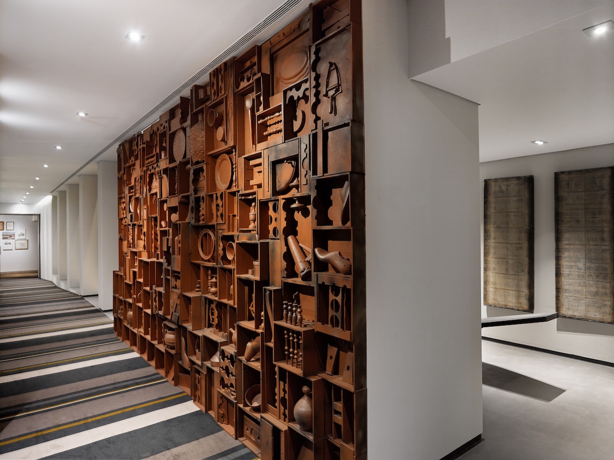 A wall of carved wood inside hotel corridor